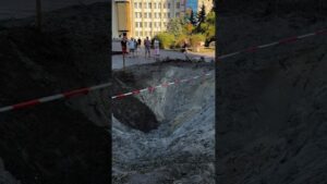 A toddler is learning to walk beside the crater left after Russia’s attack on Ukraine